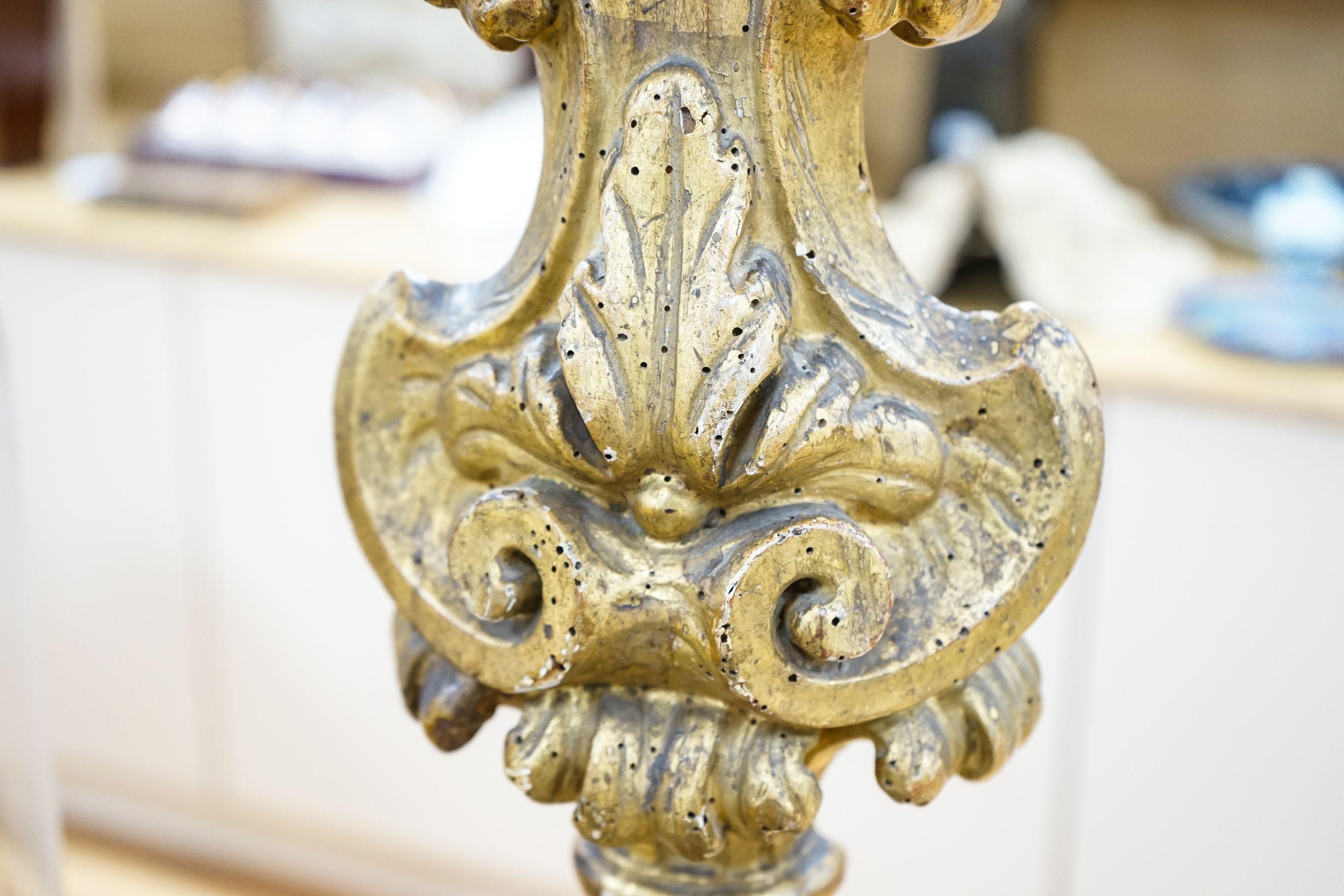 An 18th century Italian giltwood candlestand, foliate and scroll-carved